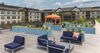 An outdoor deck with blue chairs and a gazebo